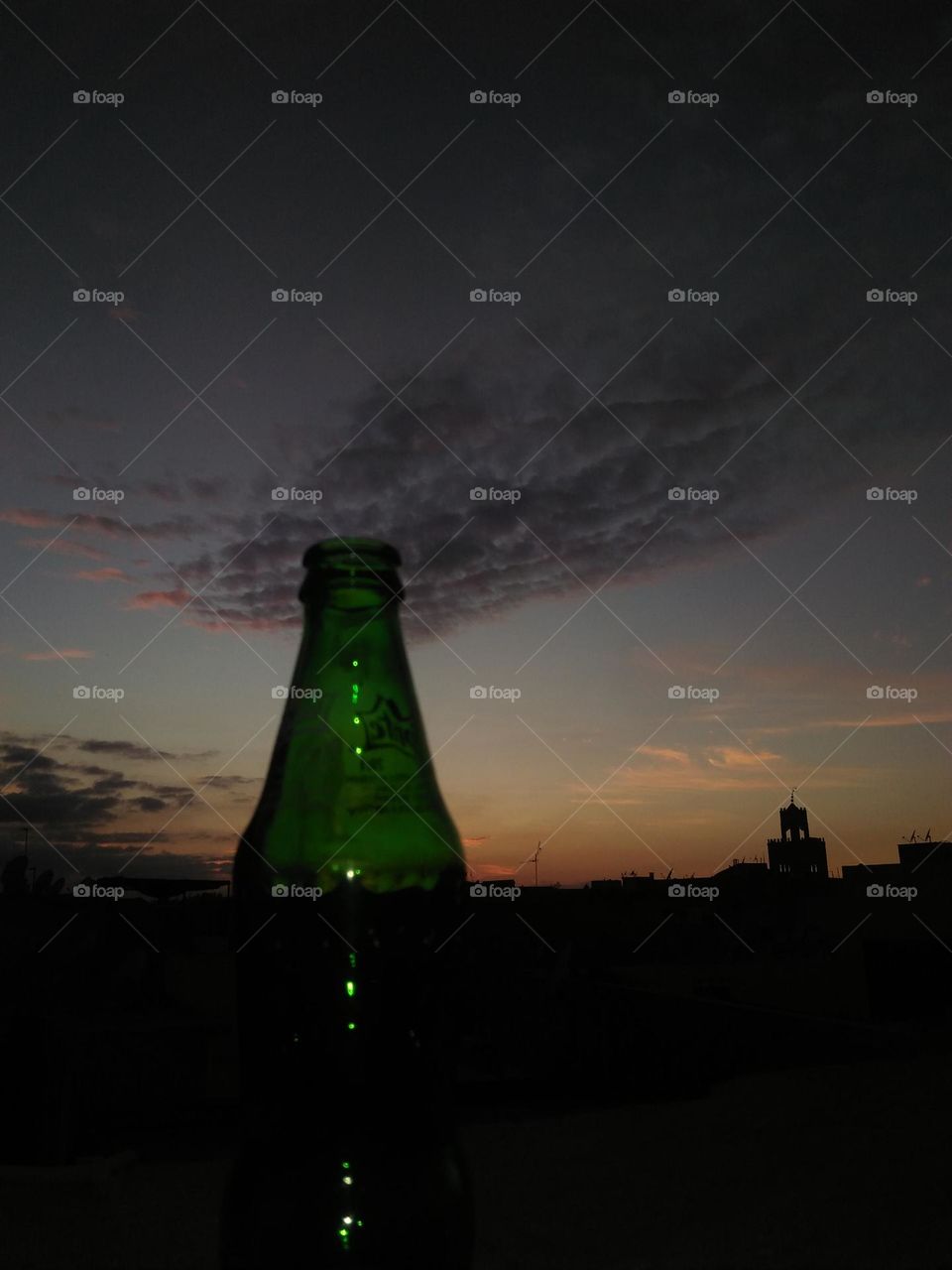 beautiful green bottle embraced scenic sky.