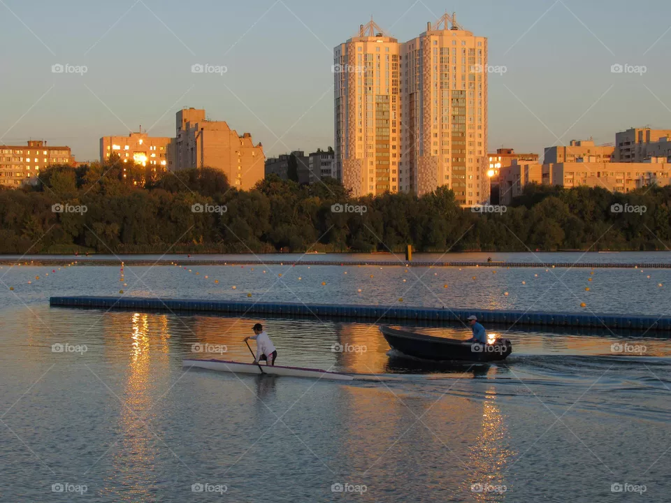 athlete training on a boat on the water in the city of Voronezh, evening, autumn,