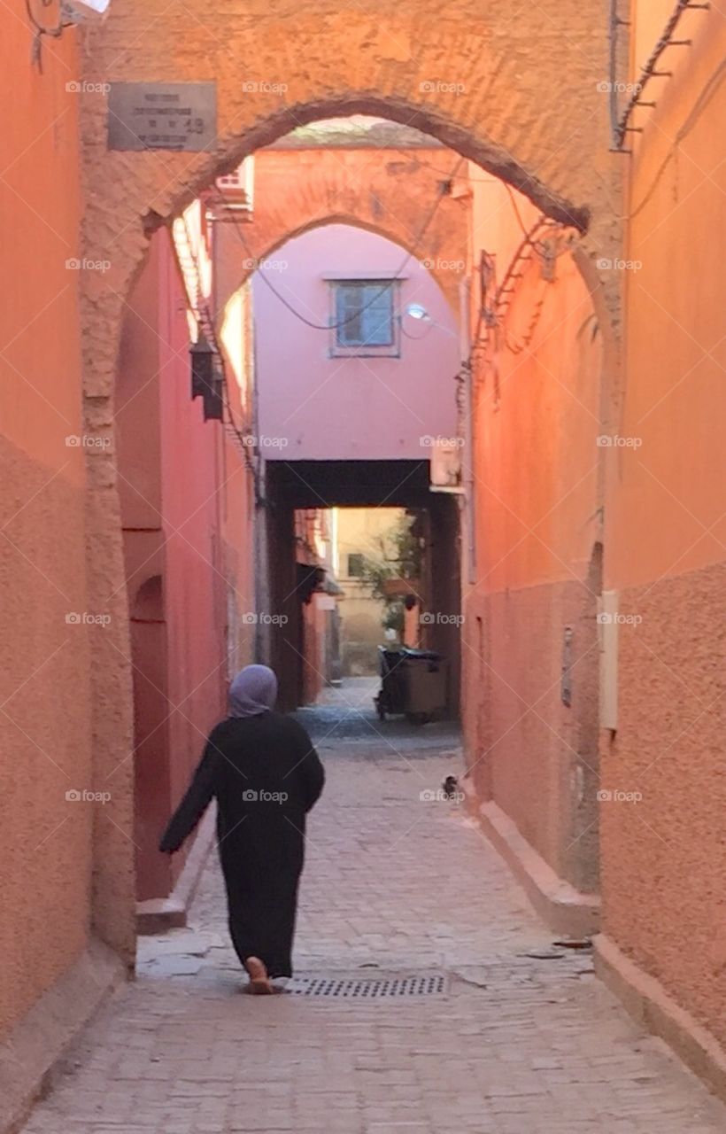 Woman walking in the medina. Woman walking through the maze of alleys in Marrakech.