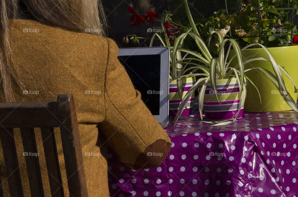 girl working on laptop outdoors