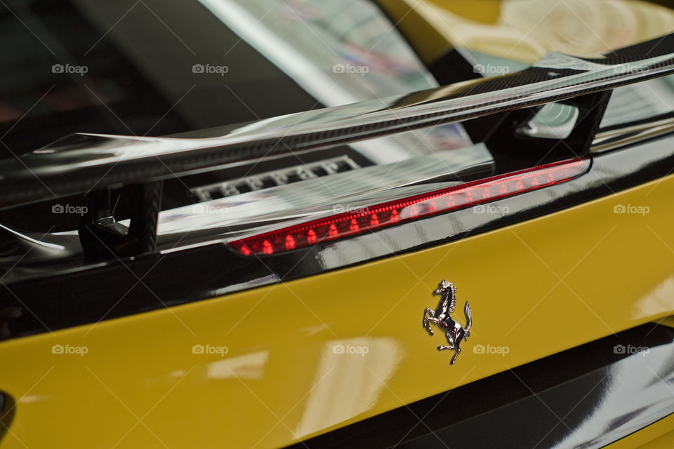 close rear view of tail light Ferrari 488 spider yellow coupe sports car, 3.9 liter V8 twin turbocharged produced by the Italian sports car - Ferrari F154CB V8
