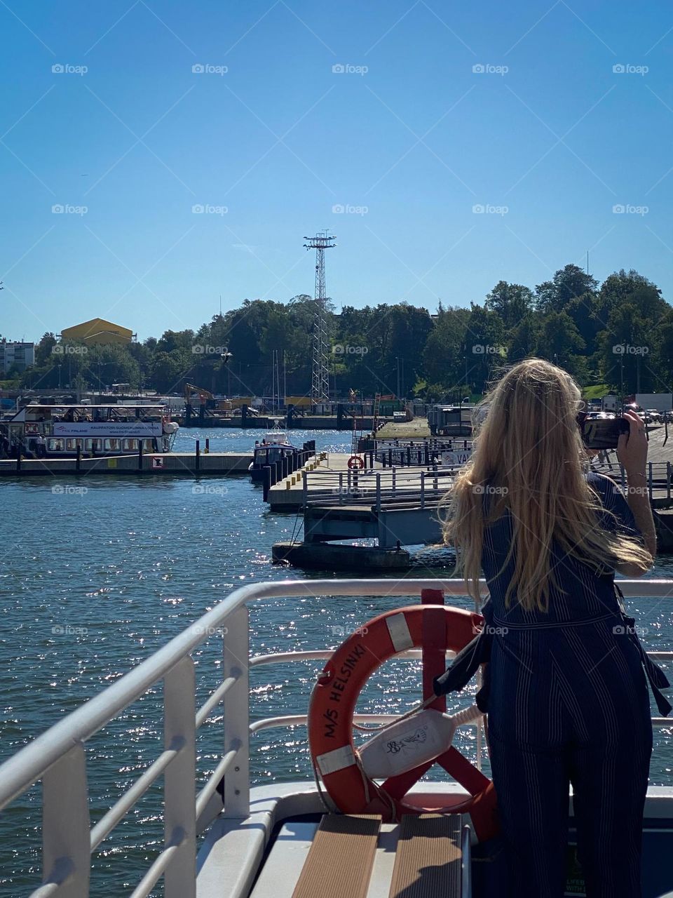 Person on tour cruise taking video of sights seem on the water. 