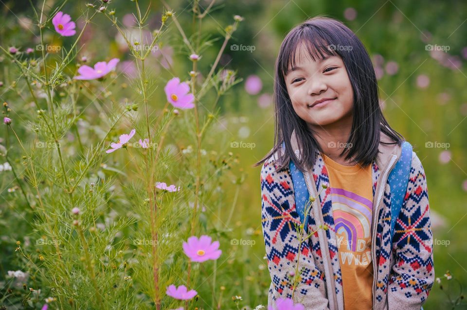 Away from the hustle and bustle of city life, a little girl enjoys the countryside life, close to nature.