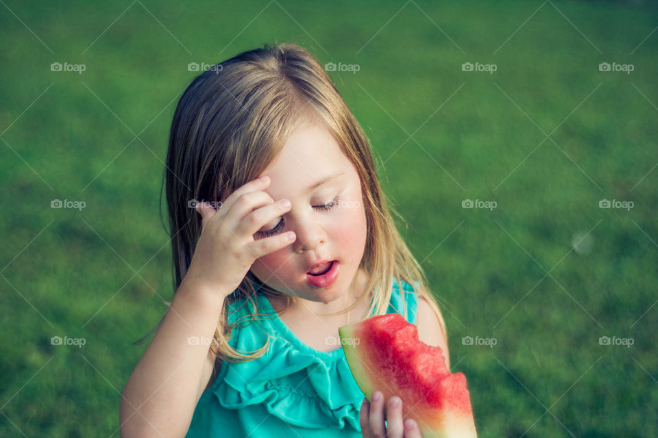 Young Girl Eating Watermelon Outside at Park 3