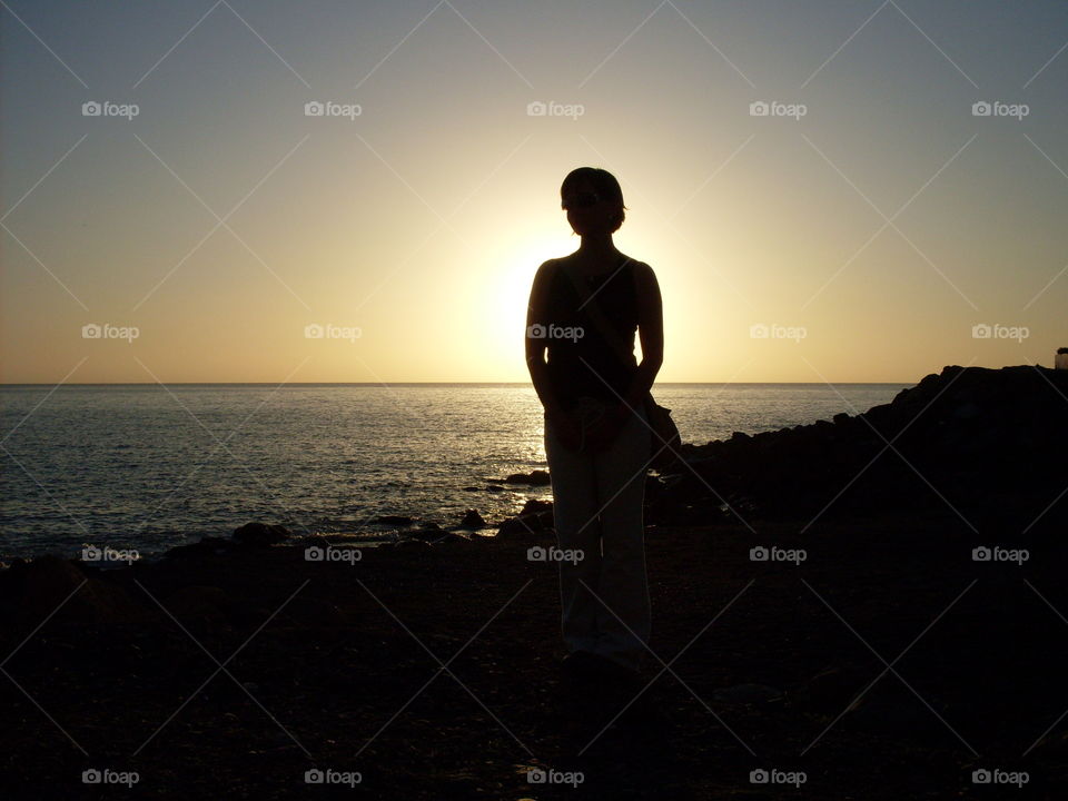 Silhouette of woman blocking sun.