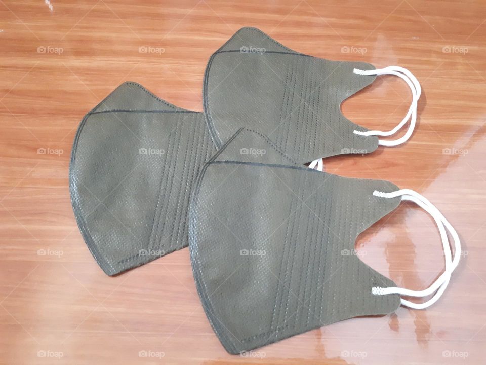 a display of brown masks on ceramic with brown wooden nuances