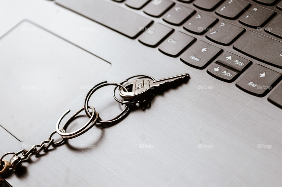 Close up of Still life of Key Ring on laptop computer keyboard. Conceptual image shown as network security key. Cyber Security, protection and privacy concepts.