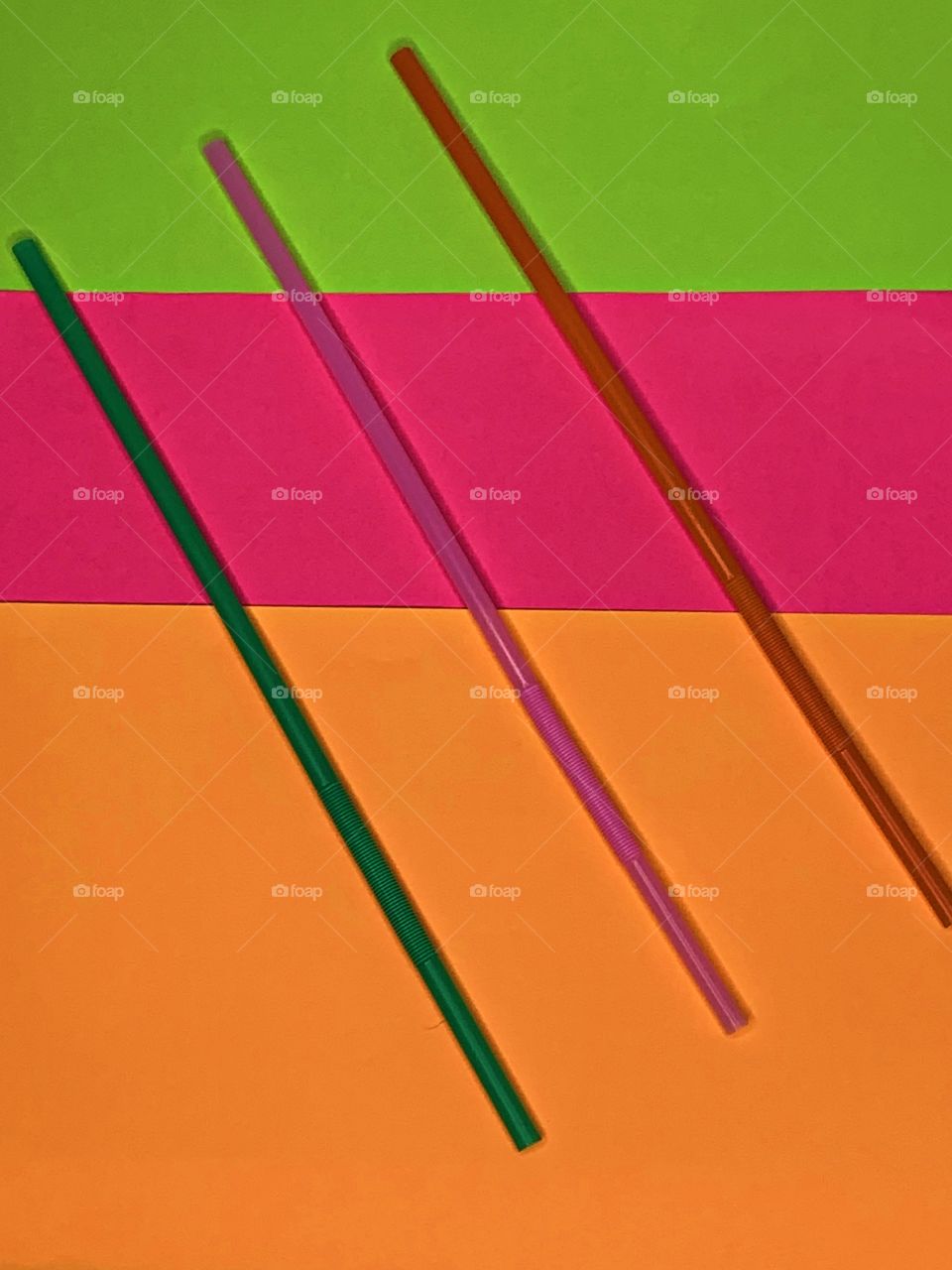 Three vertical colorful straws - The Power of Threes - Everything that comes in threes is perfect, or, every set of three is complete, conveys the same idea as the rule of three. Displayed on Bright, colorful backgrounds. 