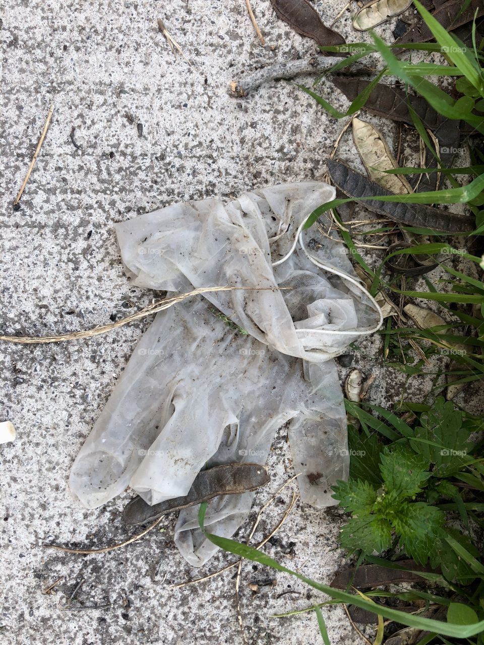 dirty surgical gloves discarded on the street floor, dirty public space,