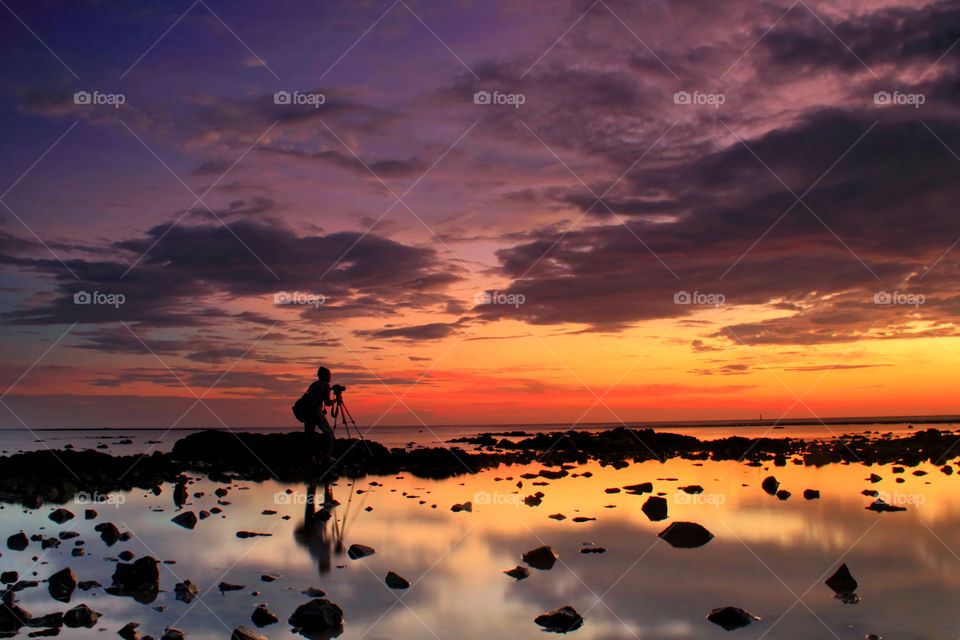 Sunset hunter. Beutiful sunset at Batakan beach, South Borneo, Indonesia.