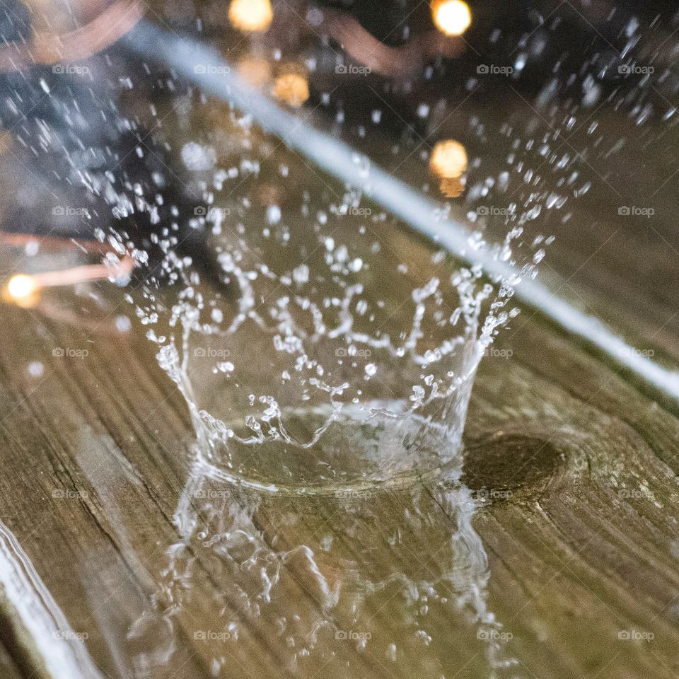A rain drop splashes of the deck