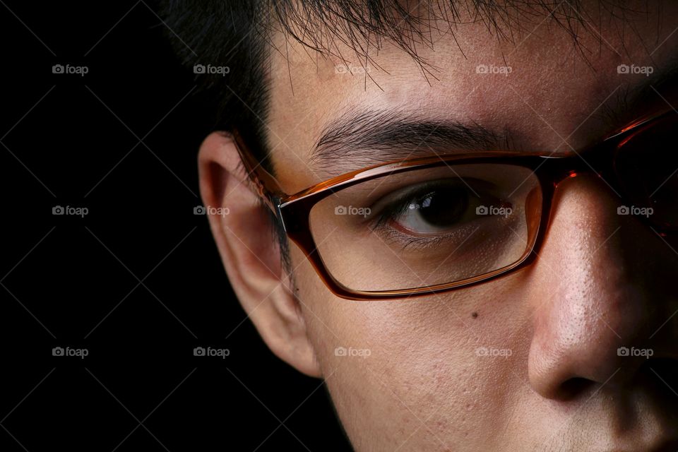 close up photo of a teenager with eyeglasses