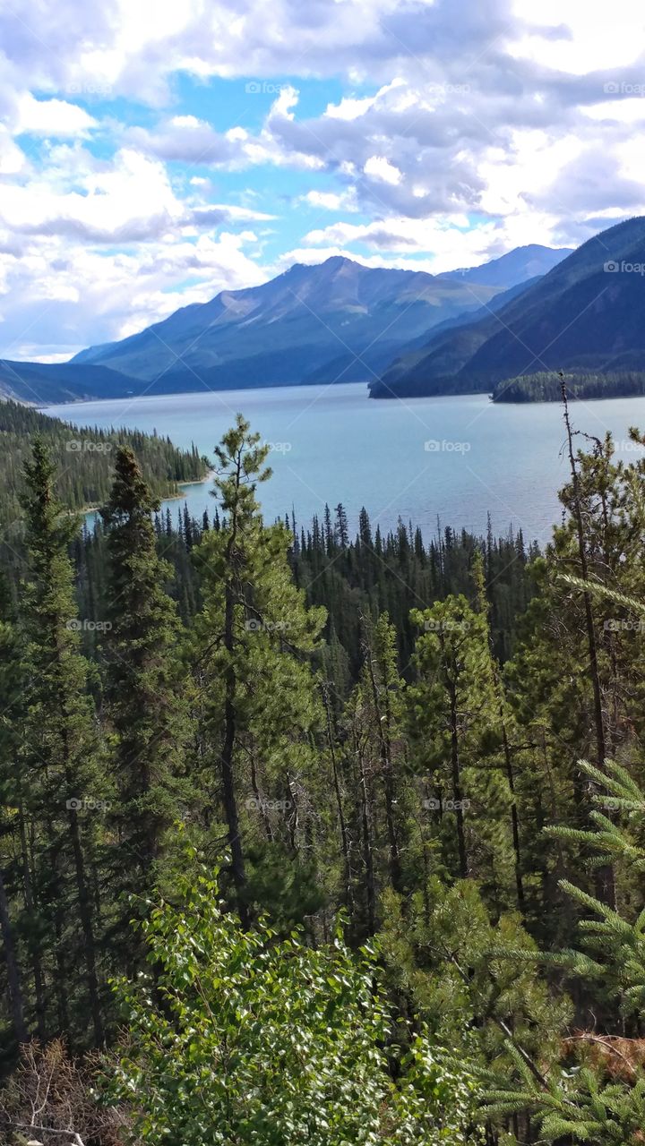 Breathtaking Muncho Lake nestled in the Northern Rocky Mountains, glimmers on a Canadian summer day.