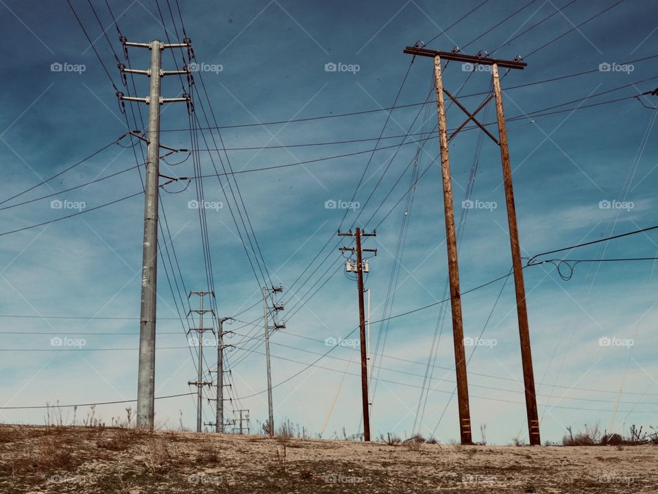 Power lines against the sky on a partly cloudy day. 