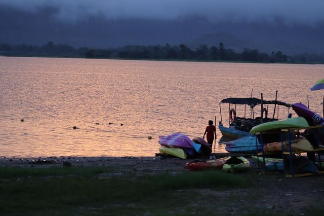 Kayaking activities with colourful kayak by the lake at sunset