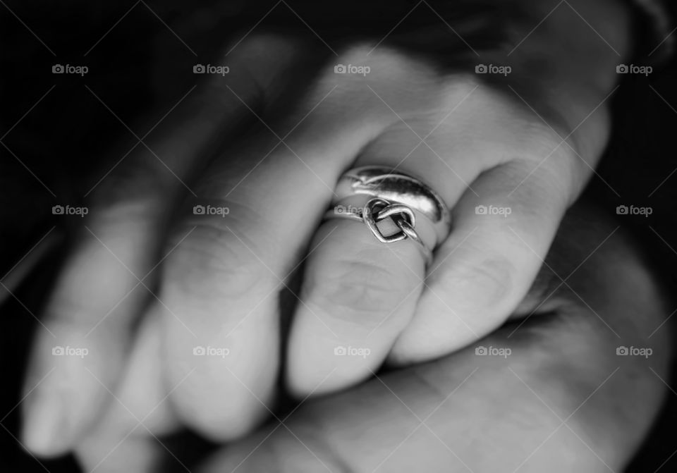 Holding hands with the one you love wearing wedding ring woman's hand with heart ring band trust showing affection