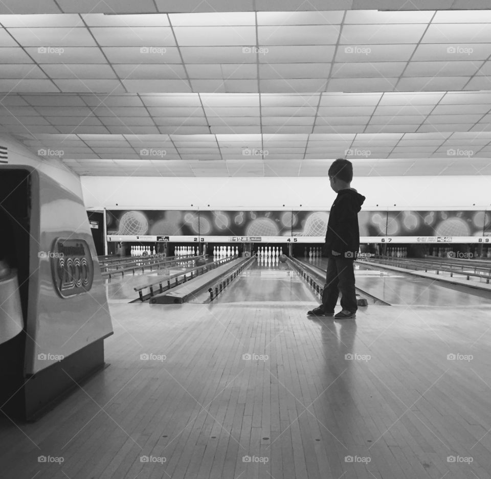 Young boy bowling alley