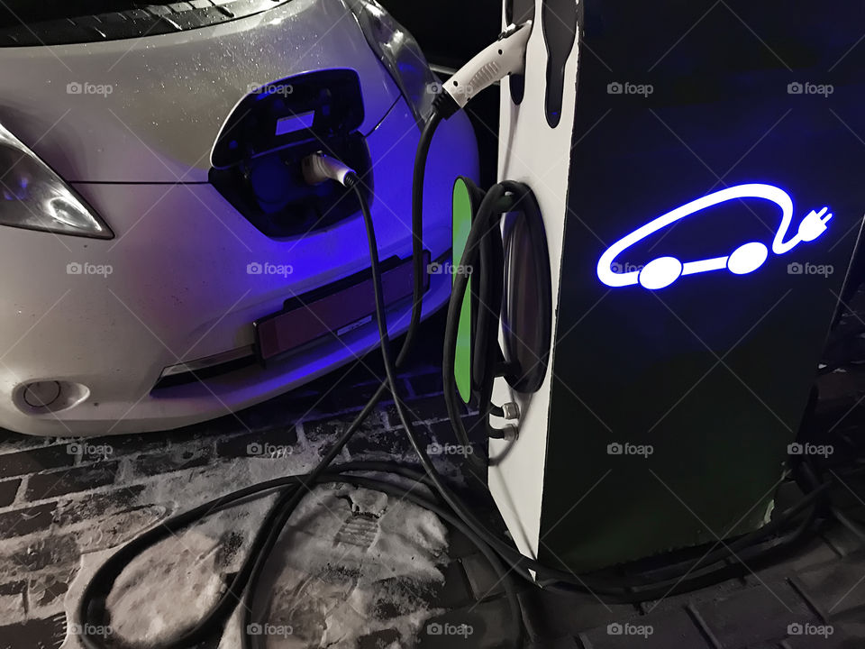 Charging electrocar during winter road trip 