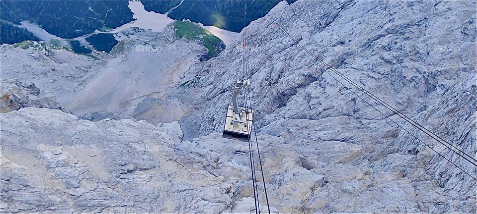 One cable car of “Seilbahn Zugspitze”, the aerial tramway that leads from “Lake Eibsee” and “Garmisch-Partenkirchen” to just below the 2962 m summit of the tallest mountain in the German “Alps” counterbalances the other. 2024. Hypnotic Productions