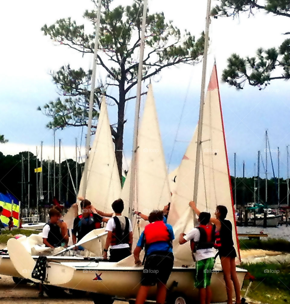 Ready to sail. Group of young people getting ready to sail