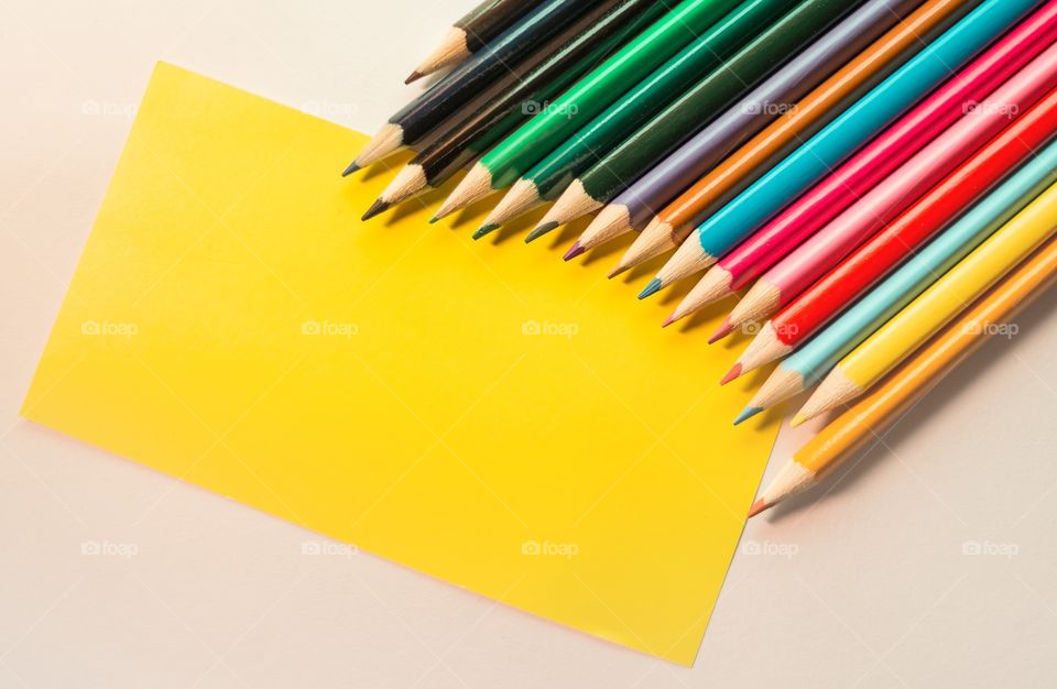 Colored pencils and yellow paper 