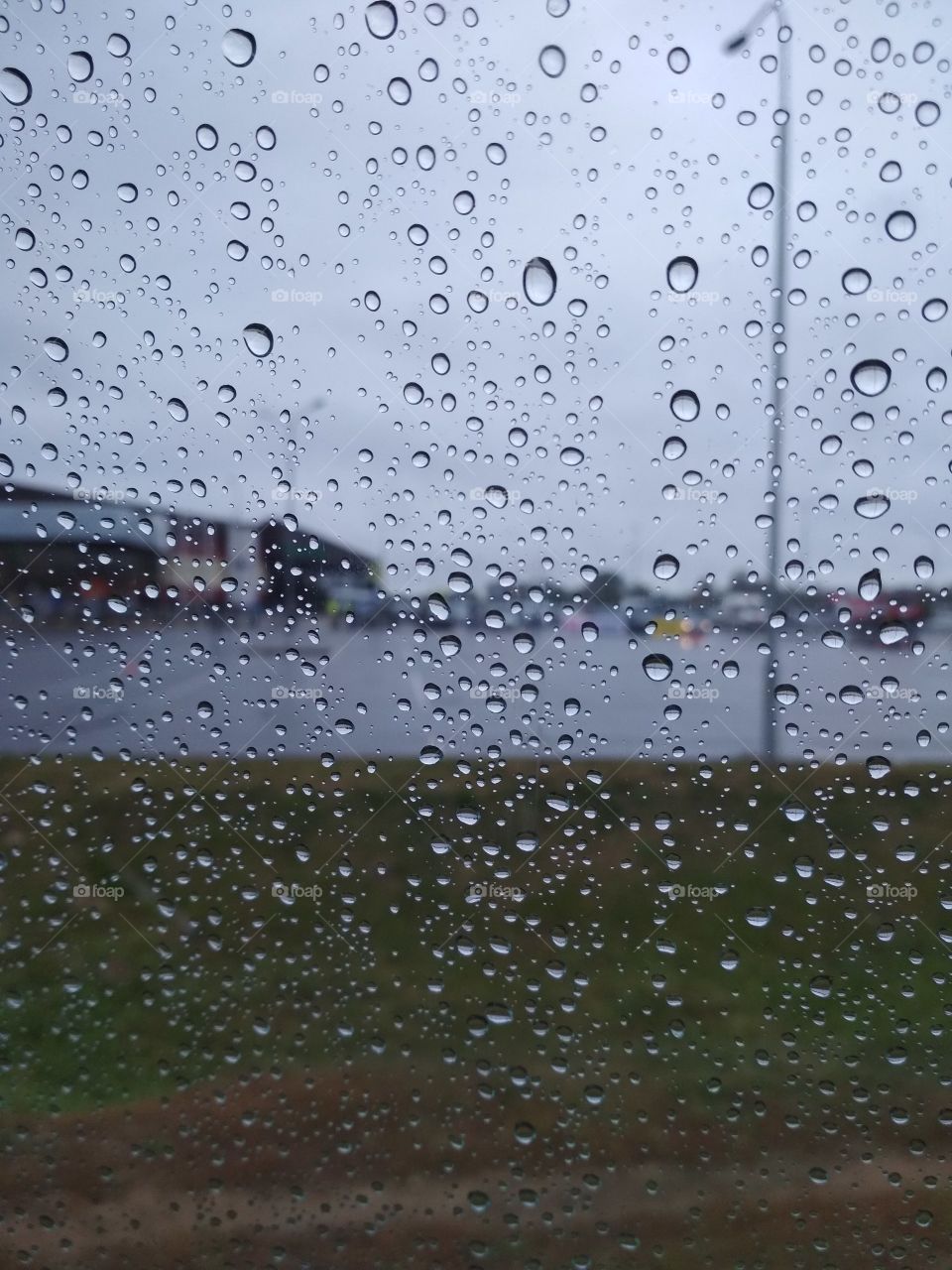 Rain production on the window in the car