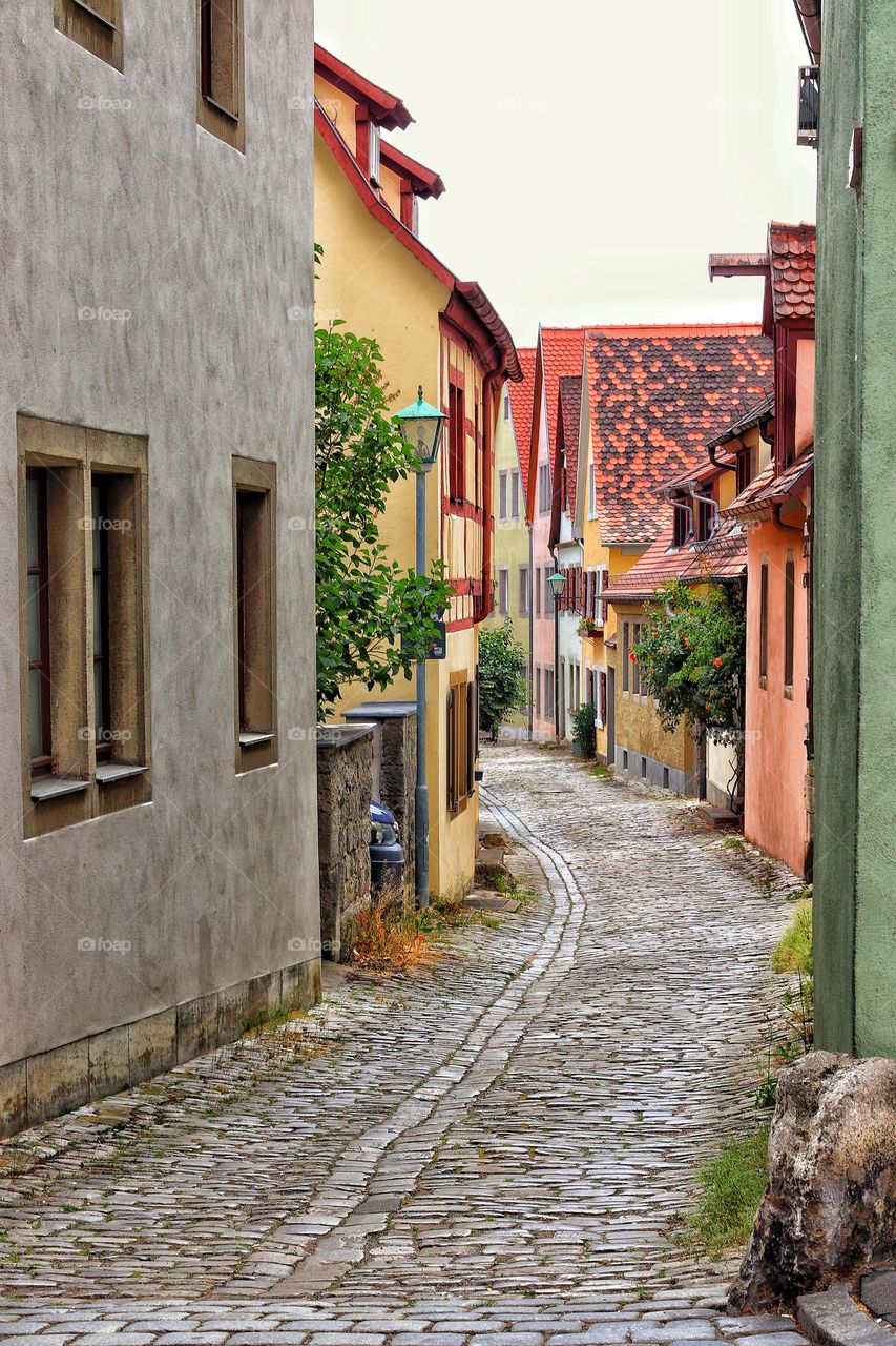 Colorful small houses in a narrow cobblestone alley