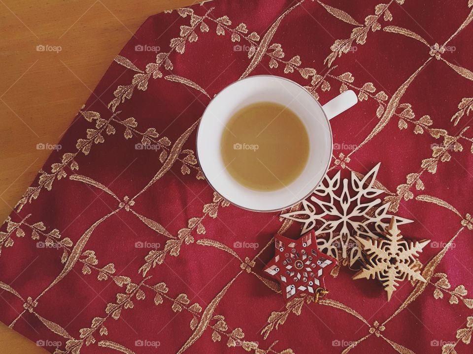 Warm cup of mint tea on festive red surface