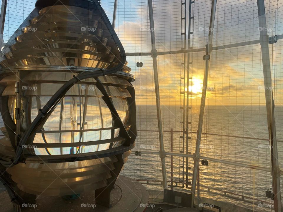 Giant light bulb in a lighthouse during sunset 