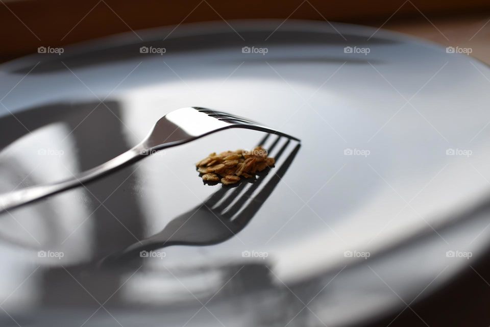 metal fork on a gray plate with oatmeal