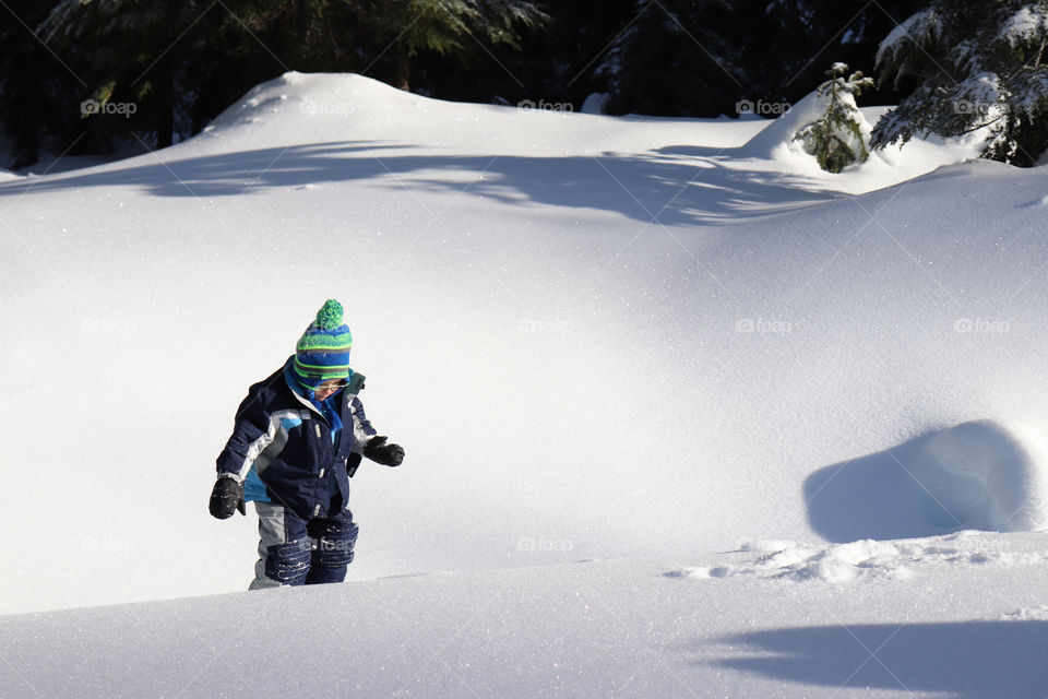 Toddler walking through the snow