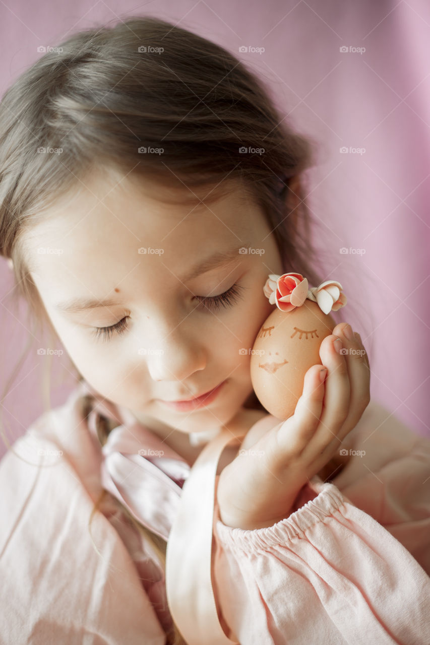Little girl with Easter egg tenderness portrait