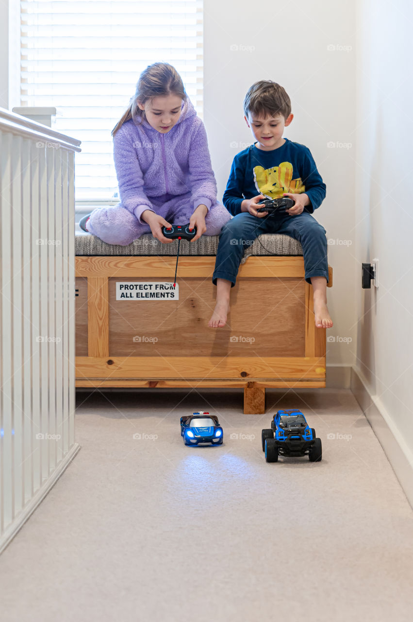 Children playing with racing cars, police chace after bad guy.