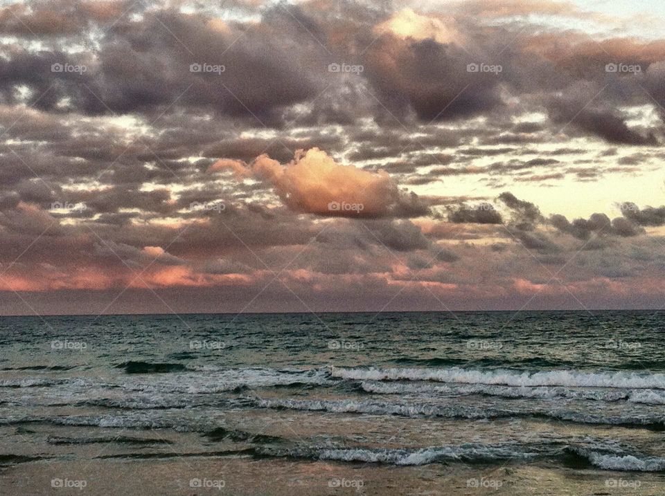 Pink and Gray Clouds at Sunset Over the Ocean