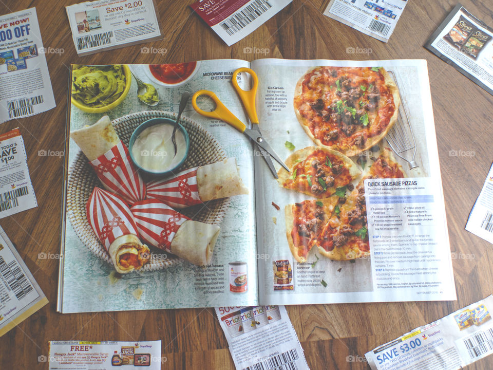 Overhead shot of clipped coupons and a magazine.