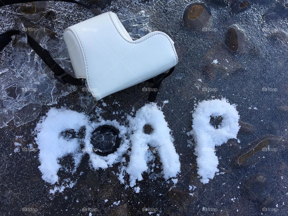 My little Sony camera placed on our local frozen river with “foap” wording made of sprinkled snow ❄️