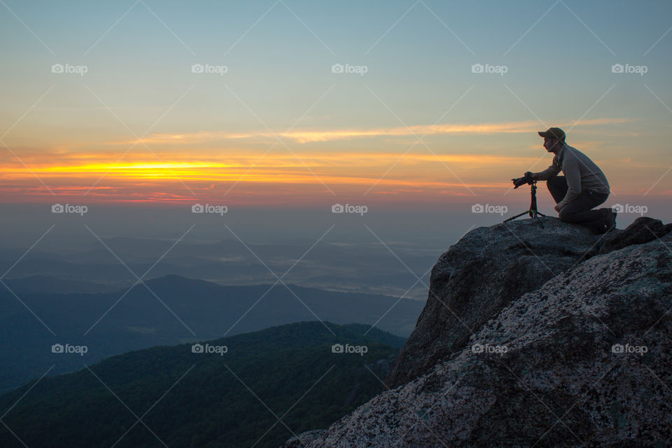 A photographer prepared his camera at dawn from the top of Old Rag Mountain, VA. 