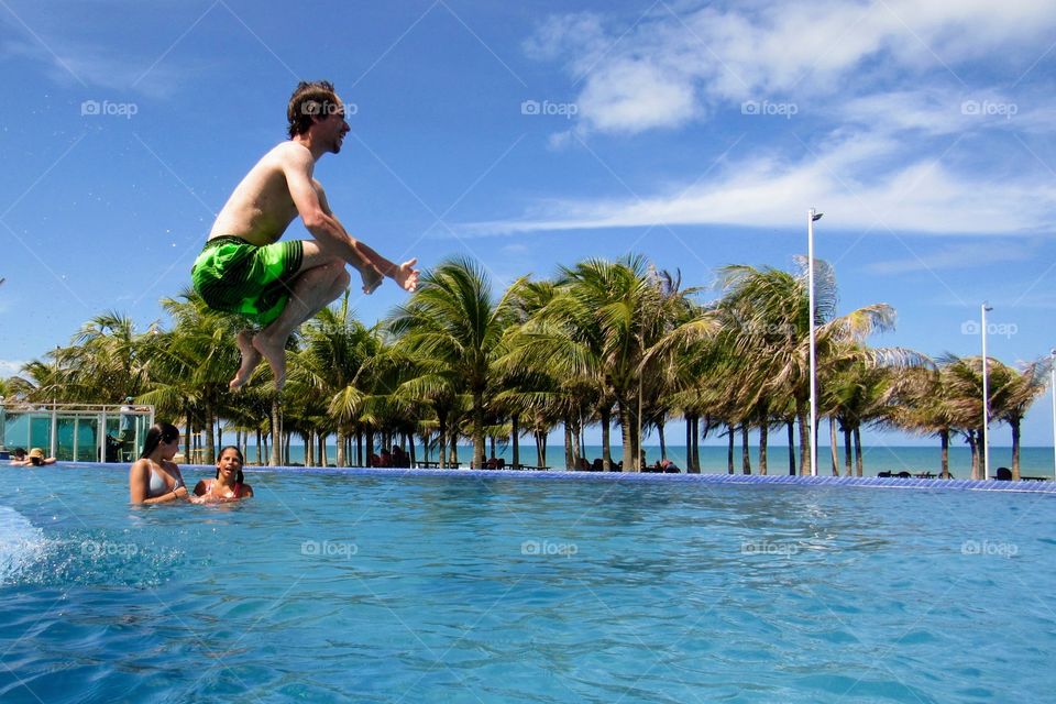 Boy jumping in the pool