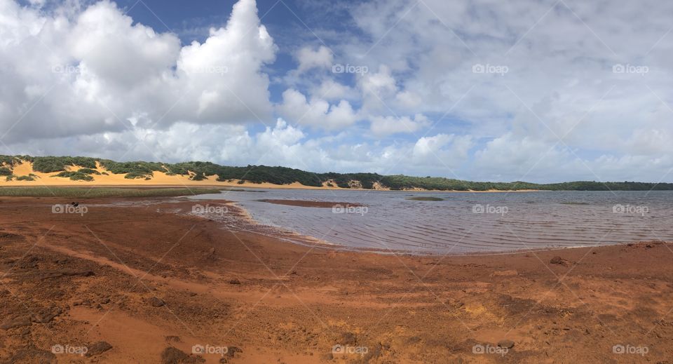 Lake surrounded by red land