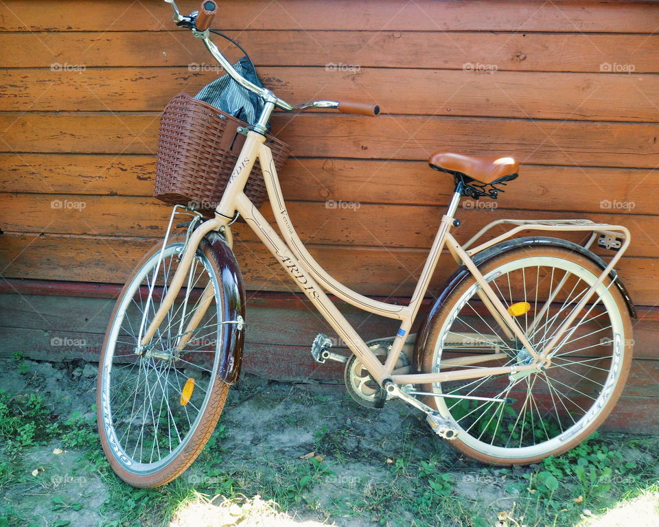 female fashionable bicycle on the background of a wooden wall