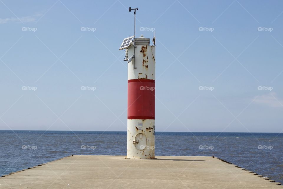 A pier with boating direction lighthouse equipment for directing maritime traffic 