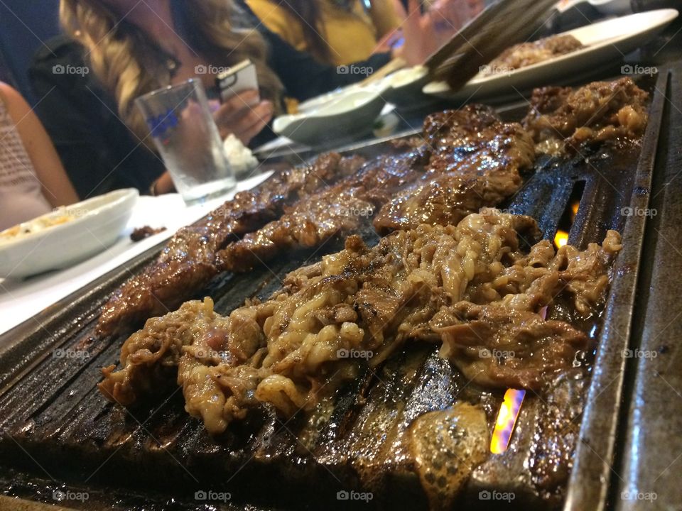 Beef grilling on a Korean grill