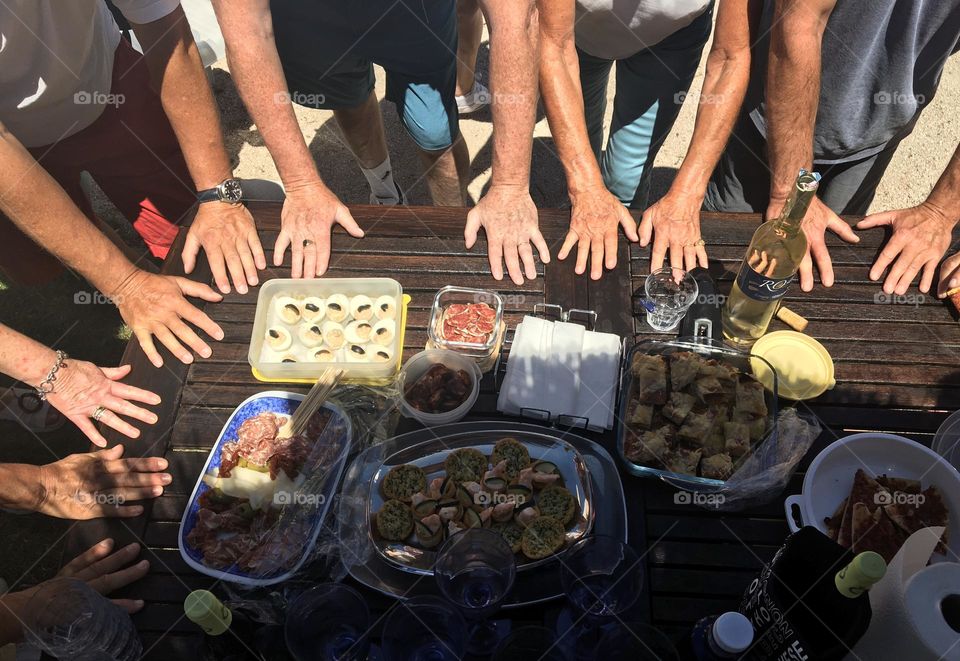 Hands on a garden table at lunchtime 