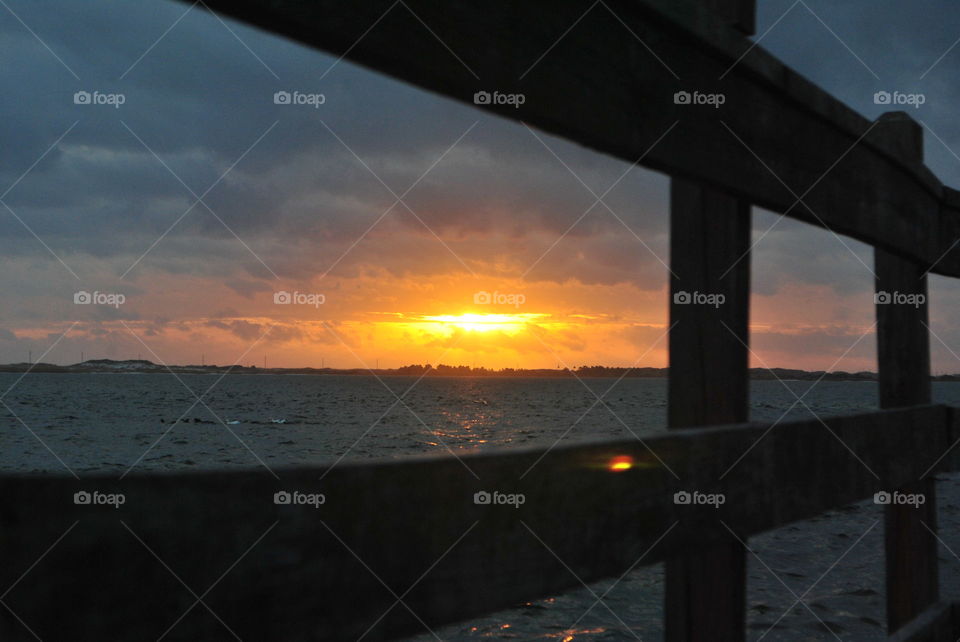 Sunset seen through the fence