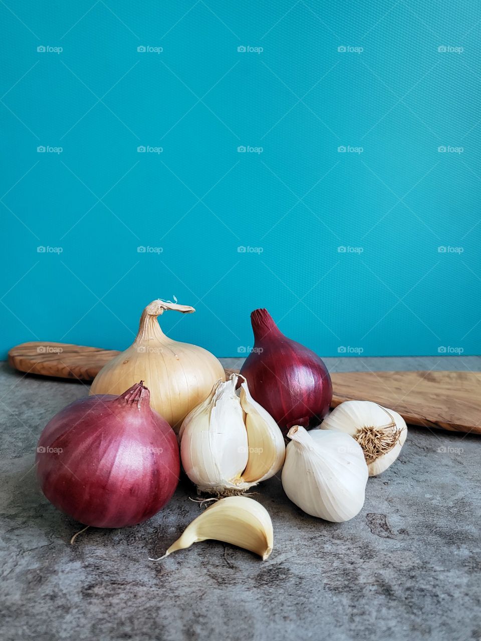 Three types of onions. Garlic, black and red onion.