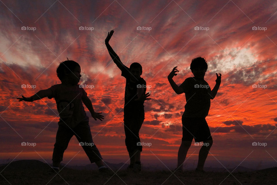 Twenty twenty - Father and children having Fun at sunset.