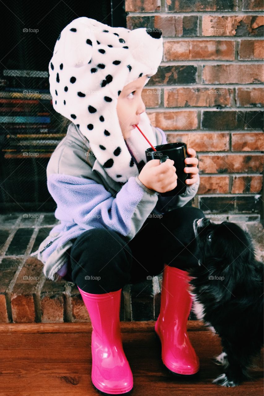 Girl sitting with black dog