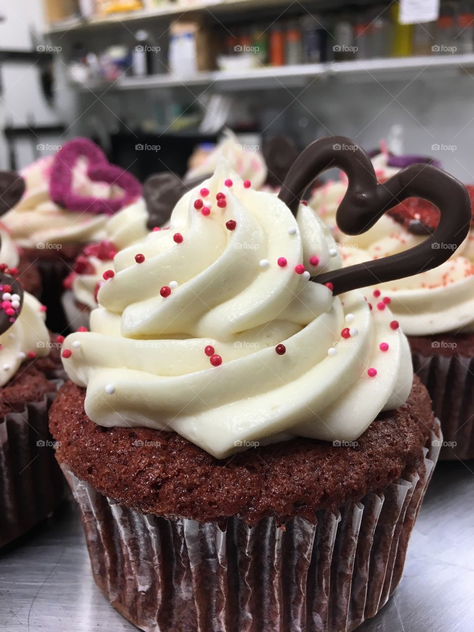 Red velvet cupcakes for Valentine's day! With cream cheese frosting topped with sprinkles and a chocolate heart. 