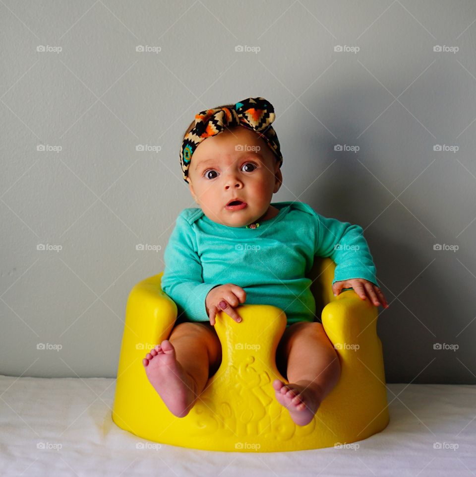 Portrait of baby sitting on toilet bowl