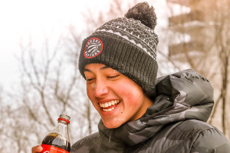 Happy teen with a bottle of coca cola